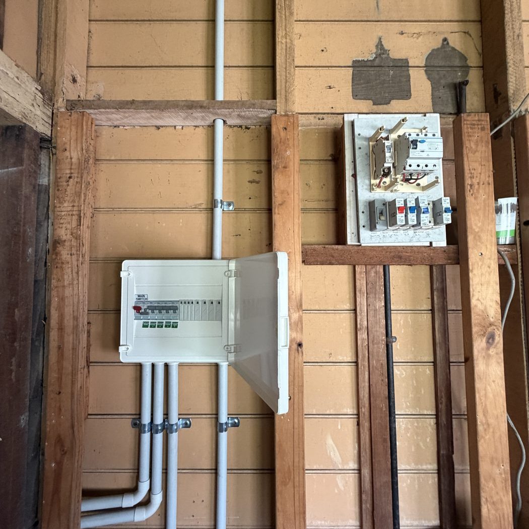 Old and new switchboard side by side during a Queenslander renovation — Ultralec Electrical switchboard upgrade